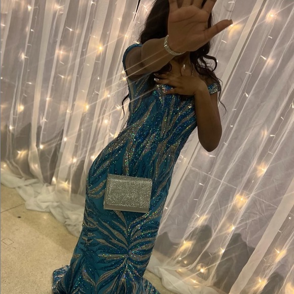 Elegant Blue Sequin Gown with Silver Clutch